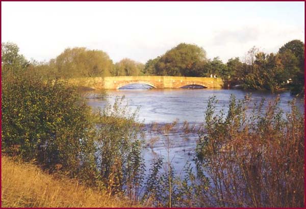 Bangor-on-Dee Bridge with the River Dee in flood looking North from the West bank